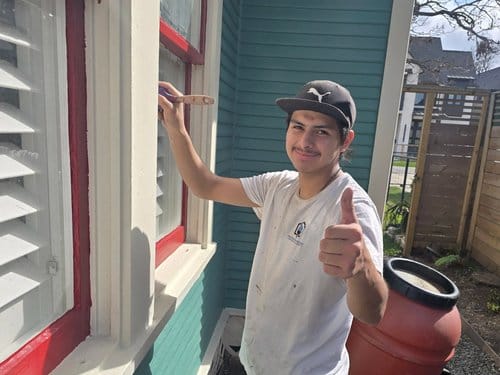 Painter working on exterior trim in Sugar Land, TX