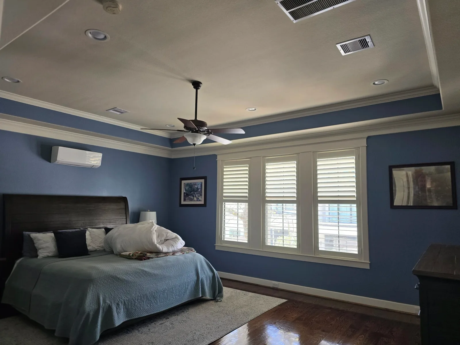 Freshly painted dark blue bedroom with tray ceiling in Southwest Houston, TX by The Proud Paintbrush