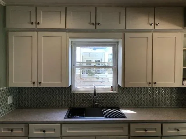 Freshly painted crisp white kitchen cabinets in Sugar Land by The Proud Paintbrush