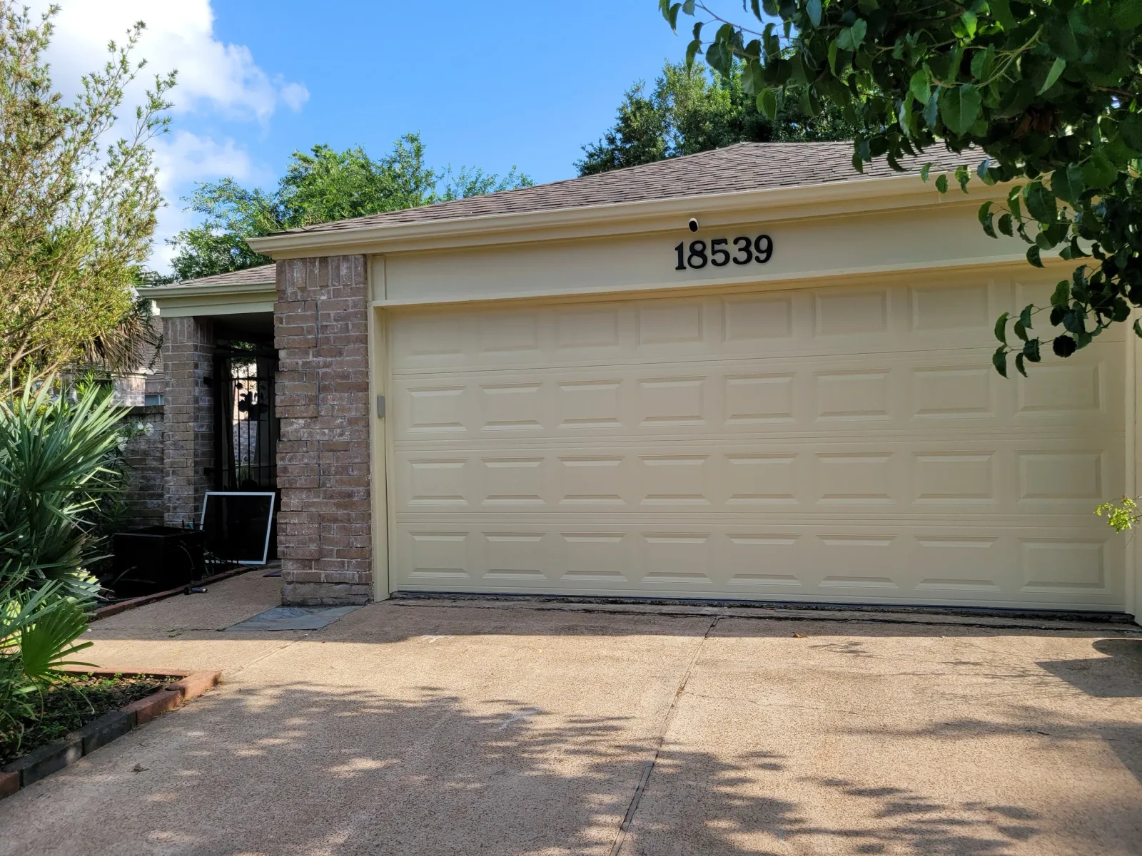 Cream Garage Door Exterior Repaint in Sugar Land, TX by The Proud Paintbrush