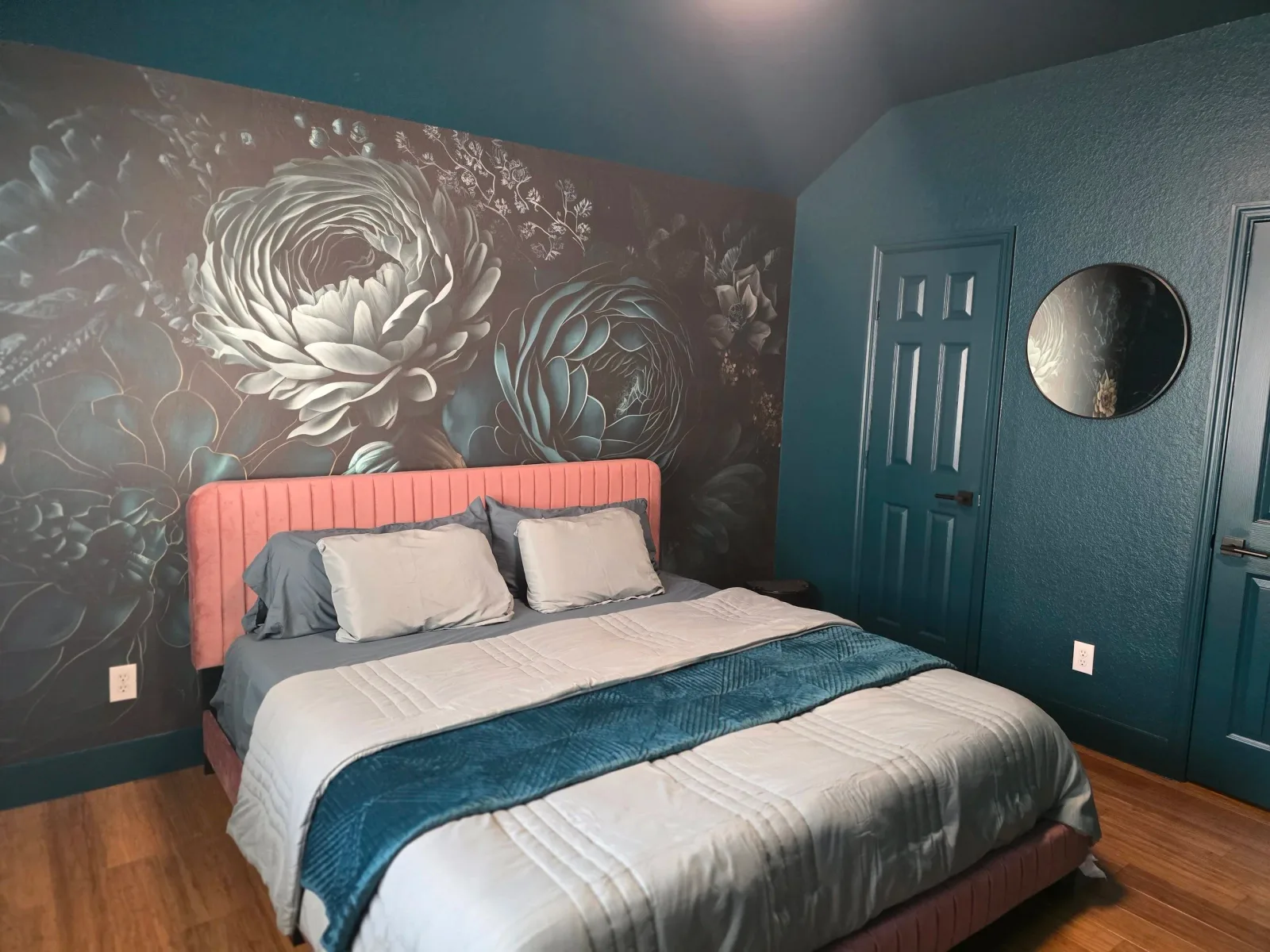 Color-drenched dark green bedroom with a bold wallpaper feature wall in Sugar Land, Texas