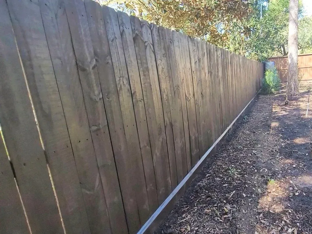 very dark brown stained fence