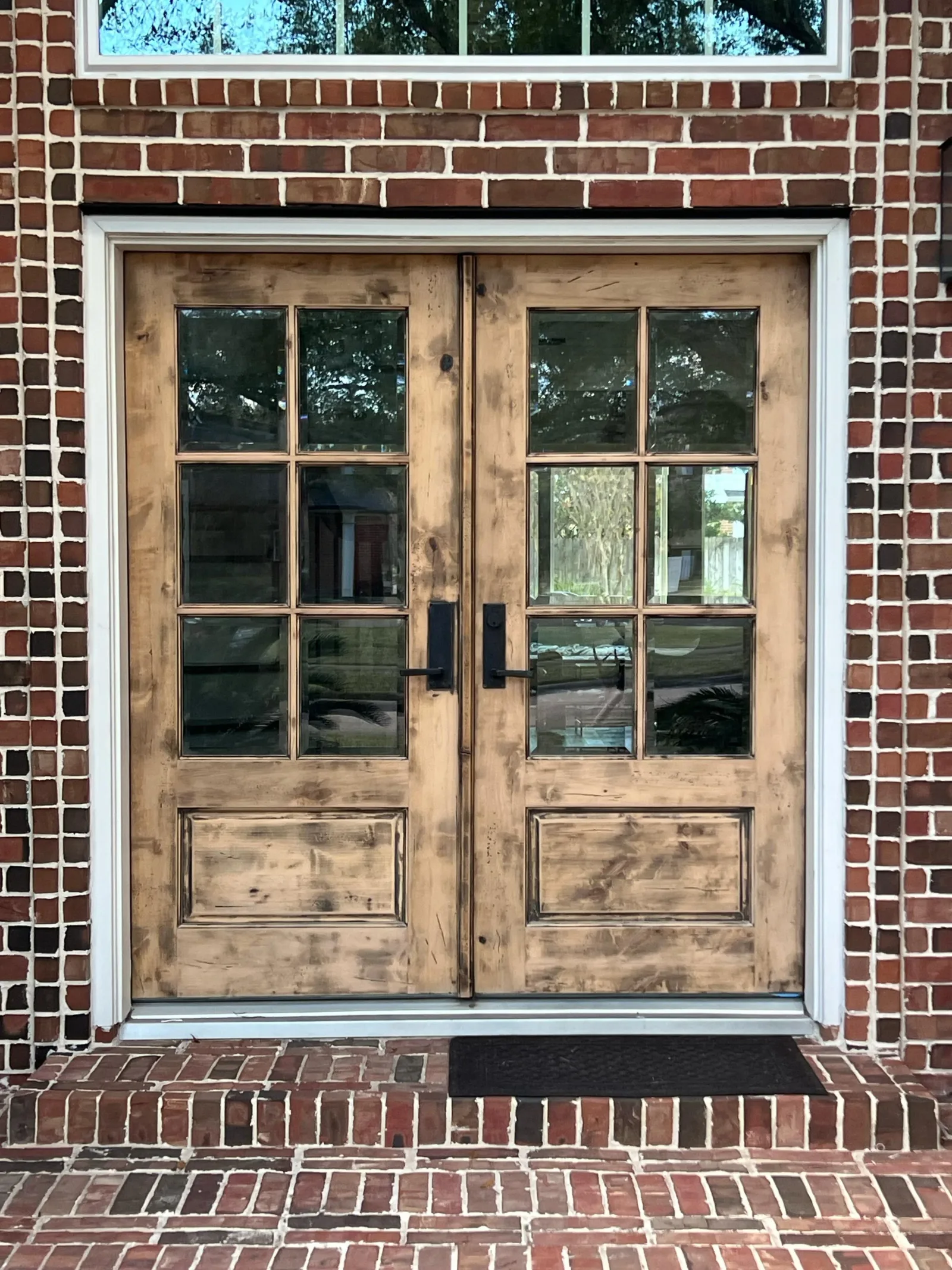 Worn, unfinished wood front door before refinishing in Rosenberg, TX by The Proud Paintbrush
