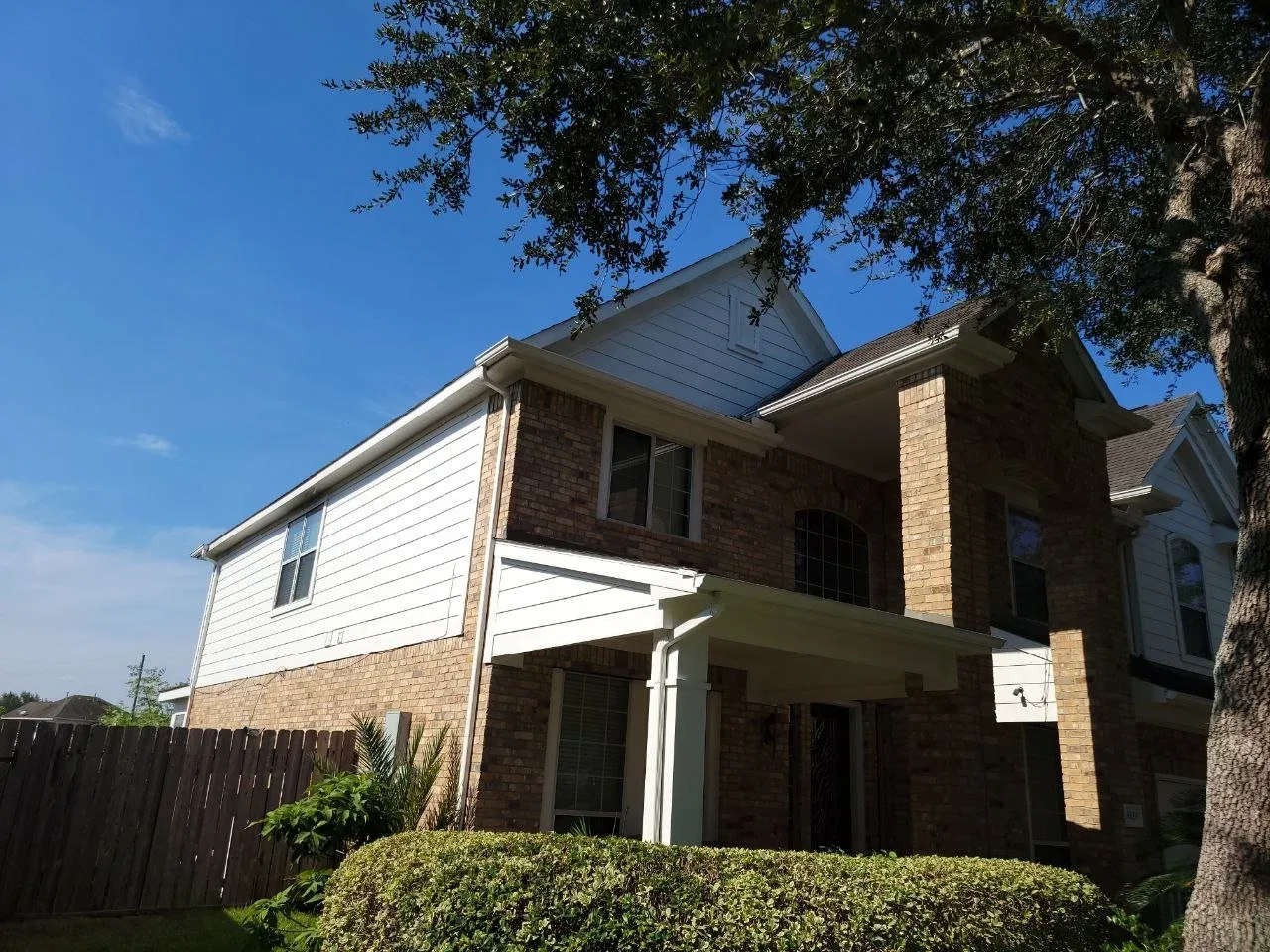 Medium-sized home with hardy board and brick exterior painted white in Richmond, Texas