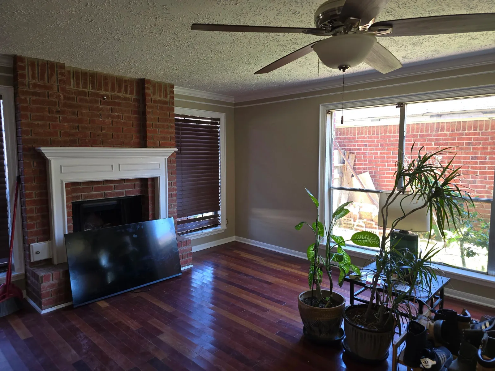 Freshly painted living room with hardwood floors by The Proud Paintbrush