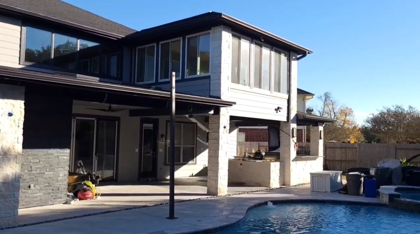 Modern Stone Exterior Pool Patio in Rosenberg, TX by The Proud Paintbrush
