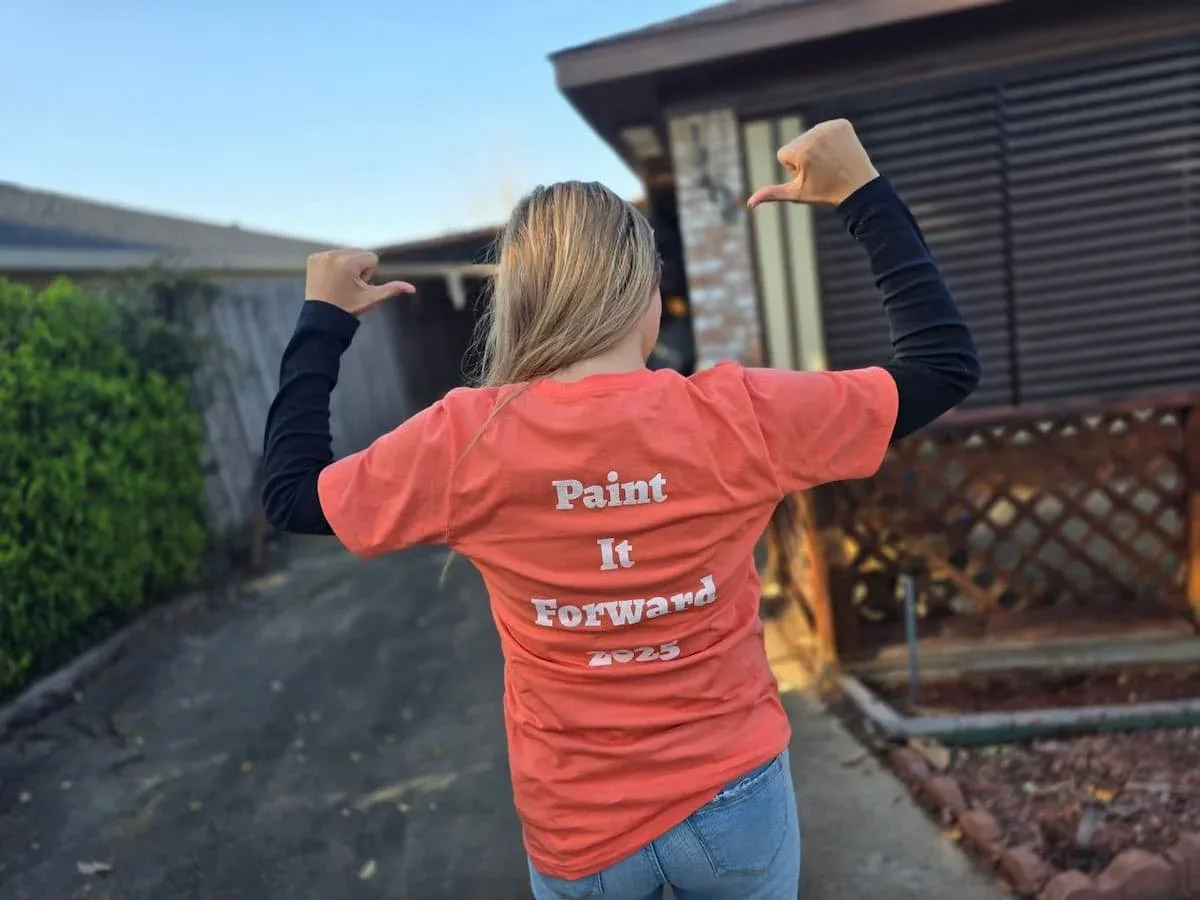 Sarah wearing a Paint It Forward shirt during The Proud Paintbrush community project in Sugar Land TX