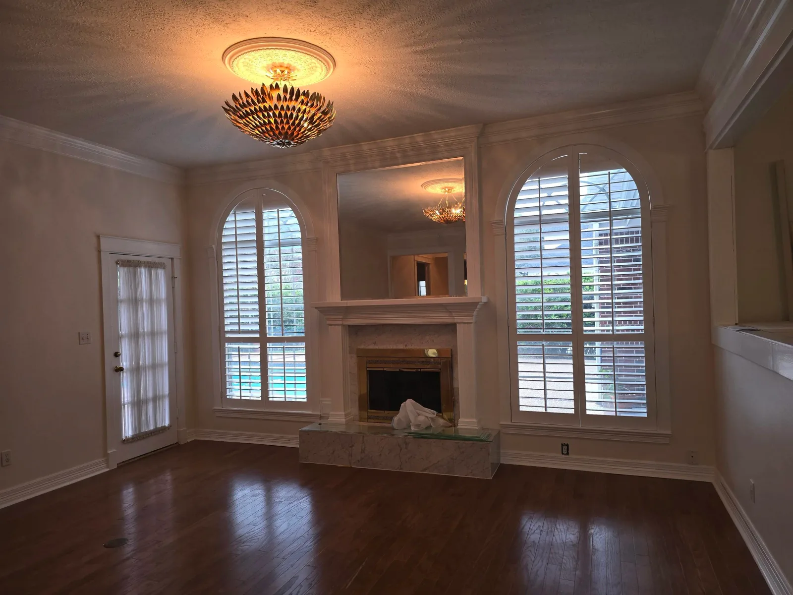 Luxury living room with warm neutral paint colors in Rosenberg, TX by The Proud Paintbrush