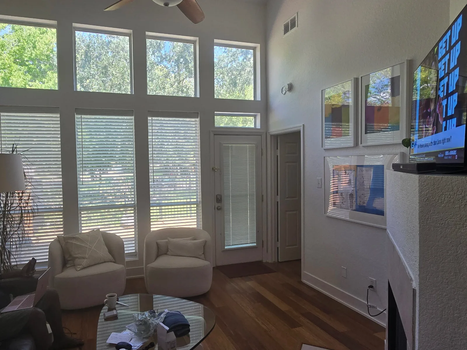 Open-concept living room with tall windows and freshly painted walls in Rosenberg, TX by The Proud Paintbrush