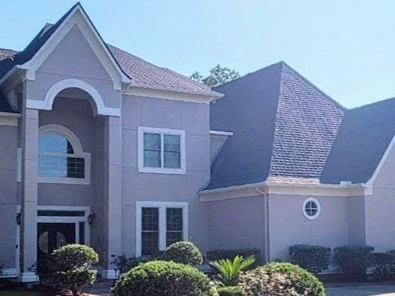 Tan Stucco Two Story Home Exterior in Fulshear, TX by The Proud Paintbrush