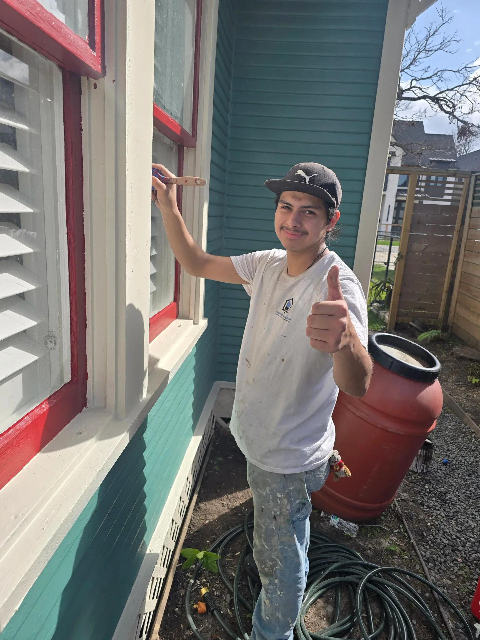 The Proud Paintbrush painter prepping a home exterior in West Houston, TX